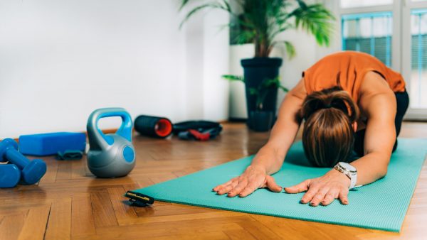 Home Exercising. Woman Stretching at Home