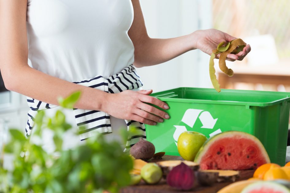 Woman composting organic kitchen waste
