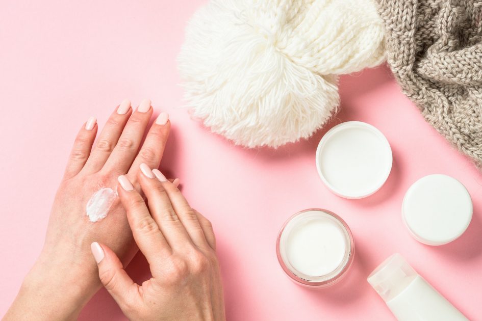 Woman using winter cream for hands