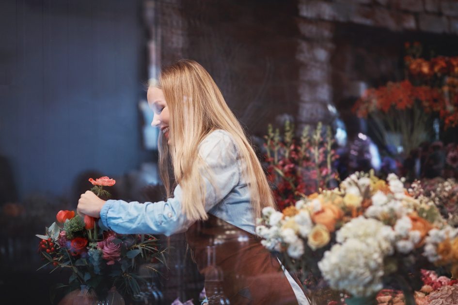 Young florist with flowers